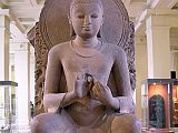 British Museum Top 20 Buddhism 03 Seated Buddha 3. Seated Buddha � Eastern India (possibly Sarnath), 5C AD, 1.18m high. This sandstone statue of Shakyamuni is notable for its posture, since it is more common to see him seated with legs crossed. Here he sits on a lion's throne with his feet on a double lotus. His hands are in the teaching mudra, delivering his first teaching in the Deer Park at Sarnath.